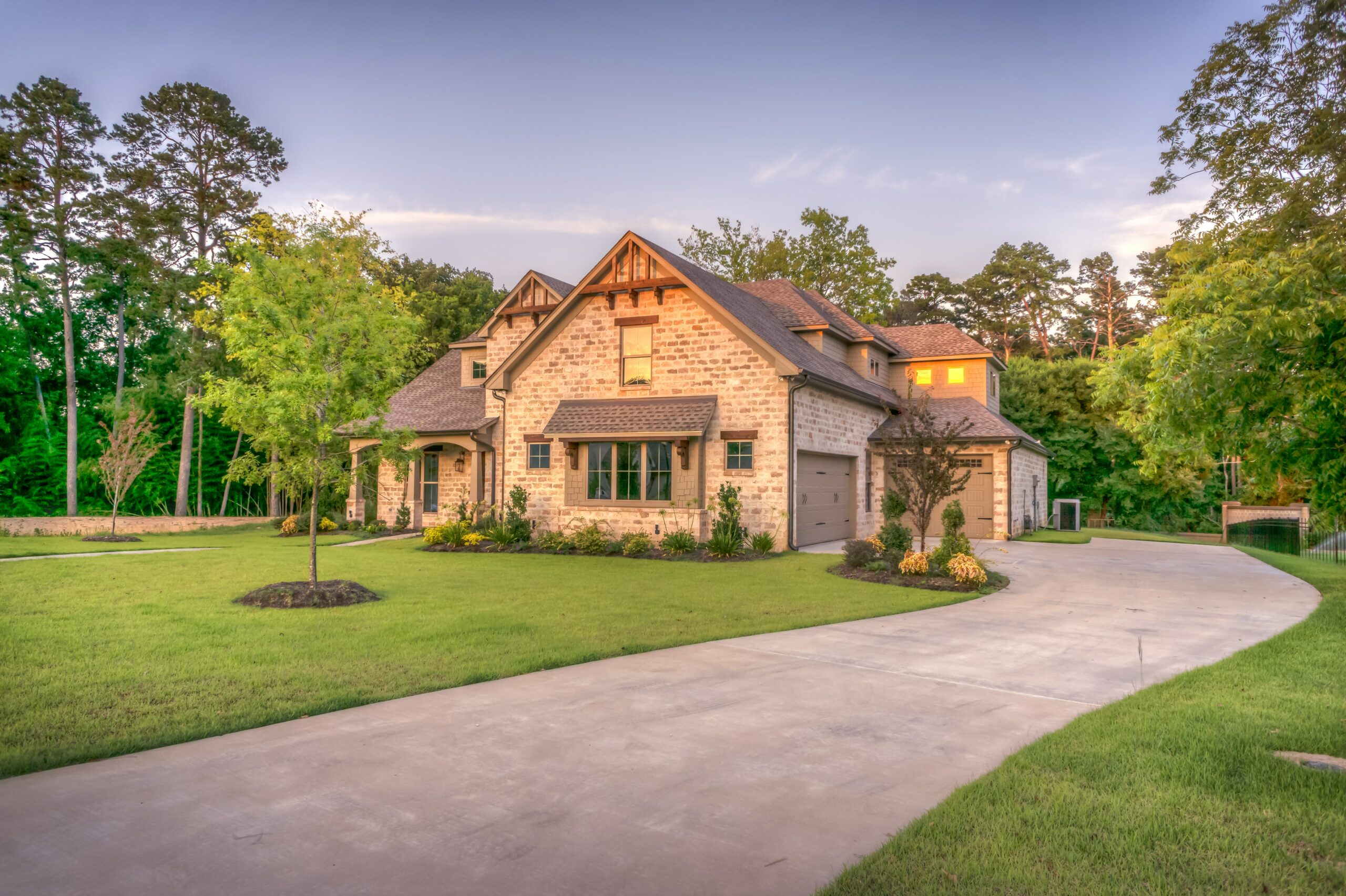 Home with green lawn and defined landscape beds